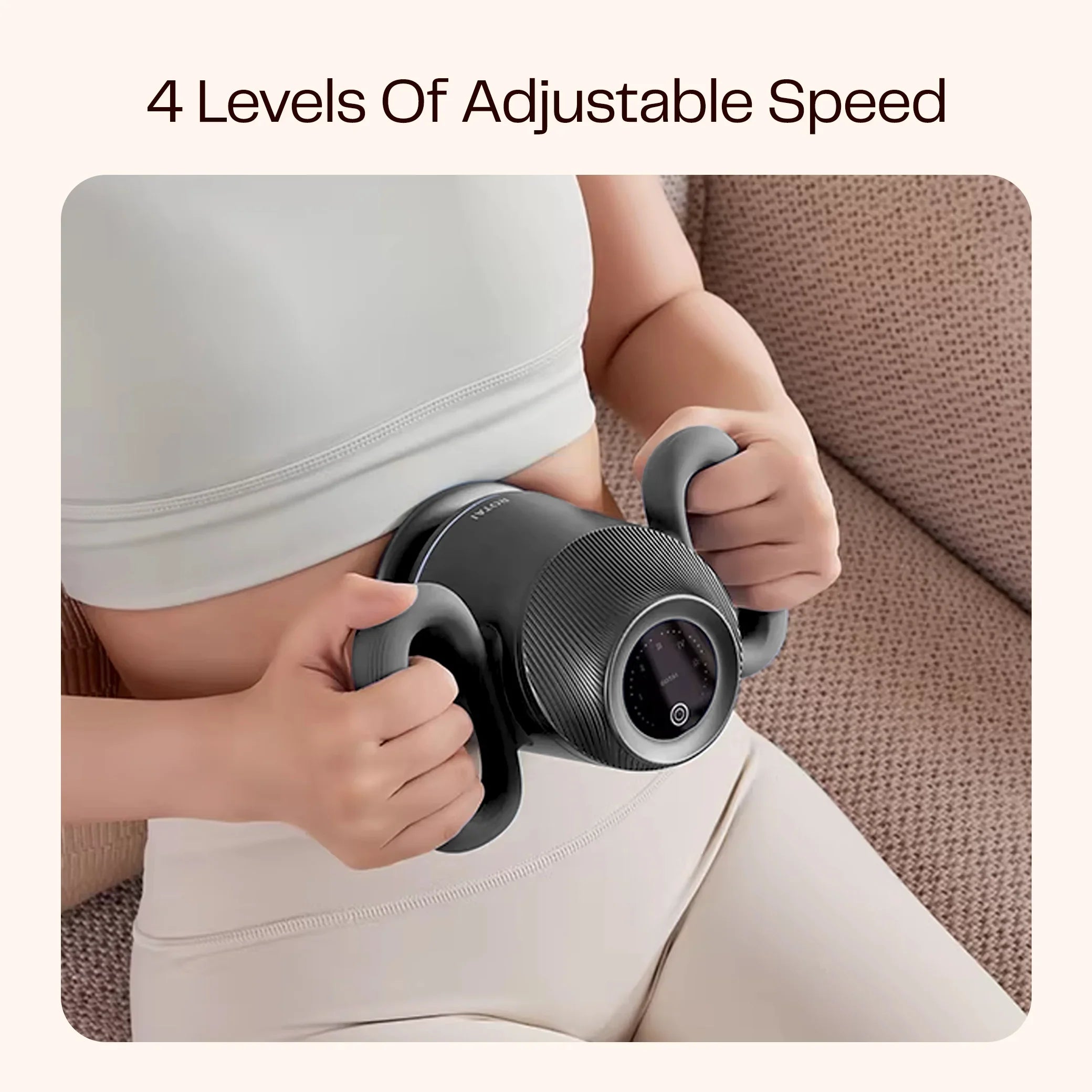 Woman using handheld full body massager with 4 adjustable speed levels on a sofa