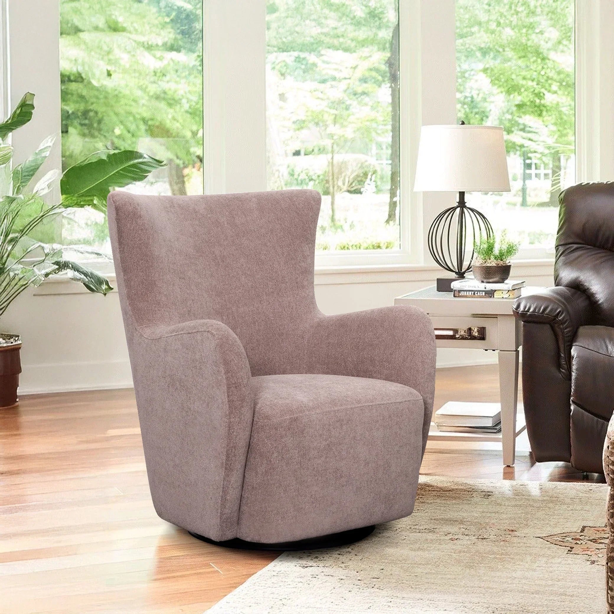 Modern ash gray swivel accent chair in bright living room with large windows