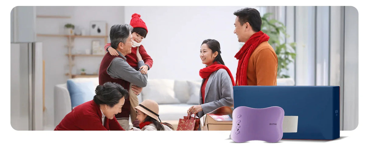 Slim waist massager device in front of a happy family exchanging gifts in a cozy living room
